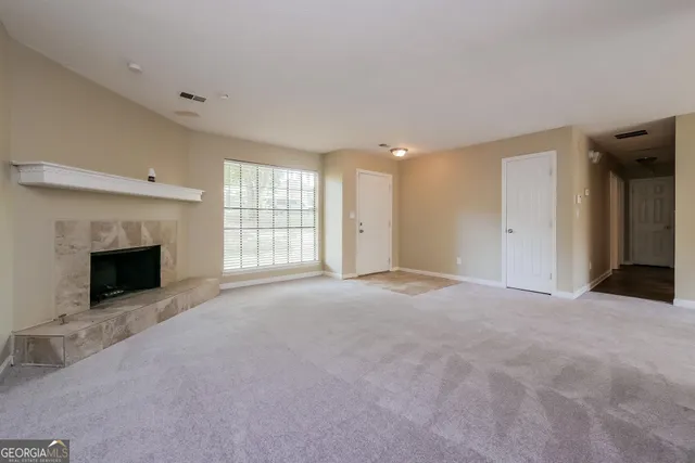 a view of an empty room with a fireplace