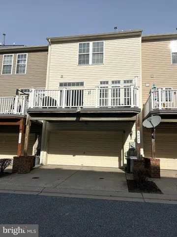a roof deck with couches and wooden floor