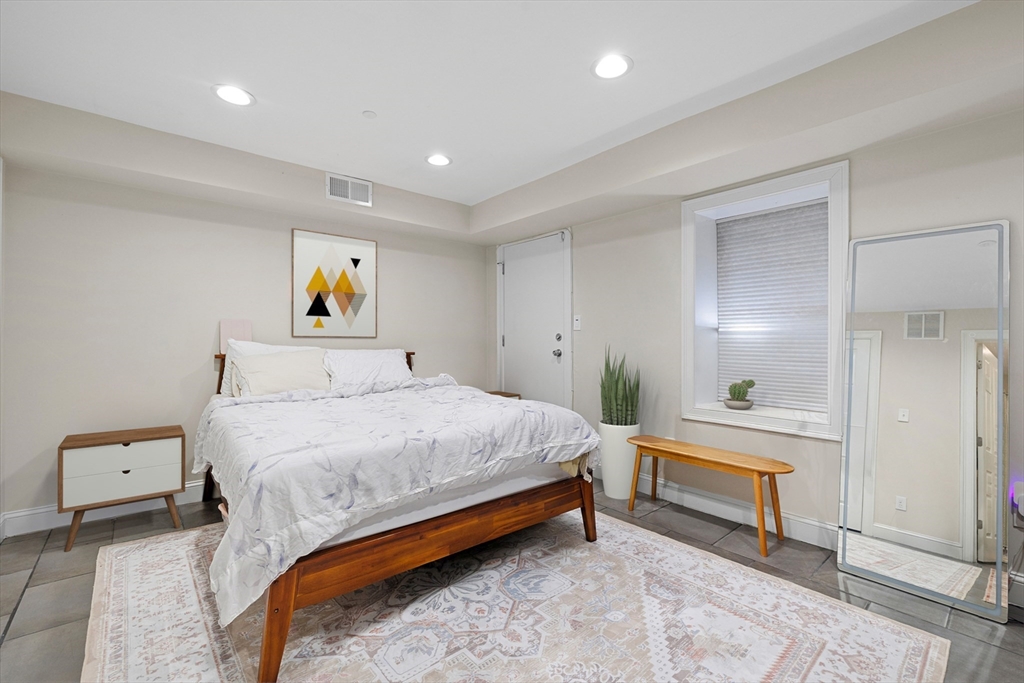 110 Chelsea Street, Unit 1 Boston, MA 02128 - Photo 7 of 12 a bedroom with a bed and painting on the wall