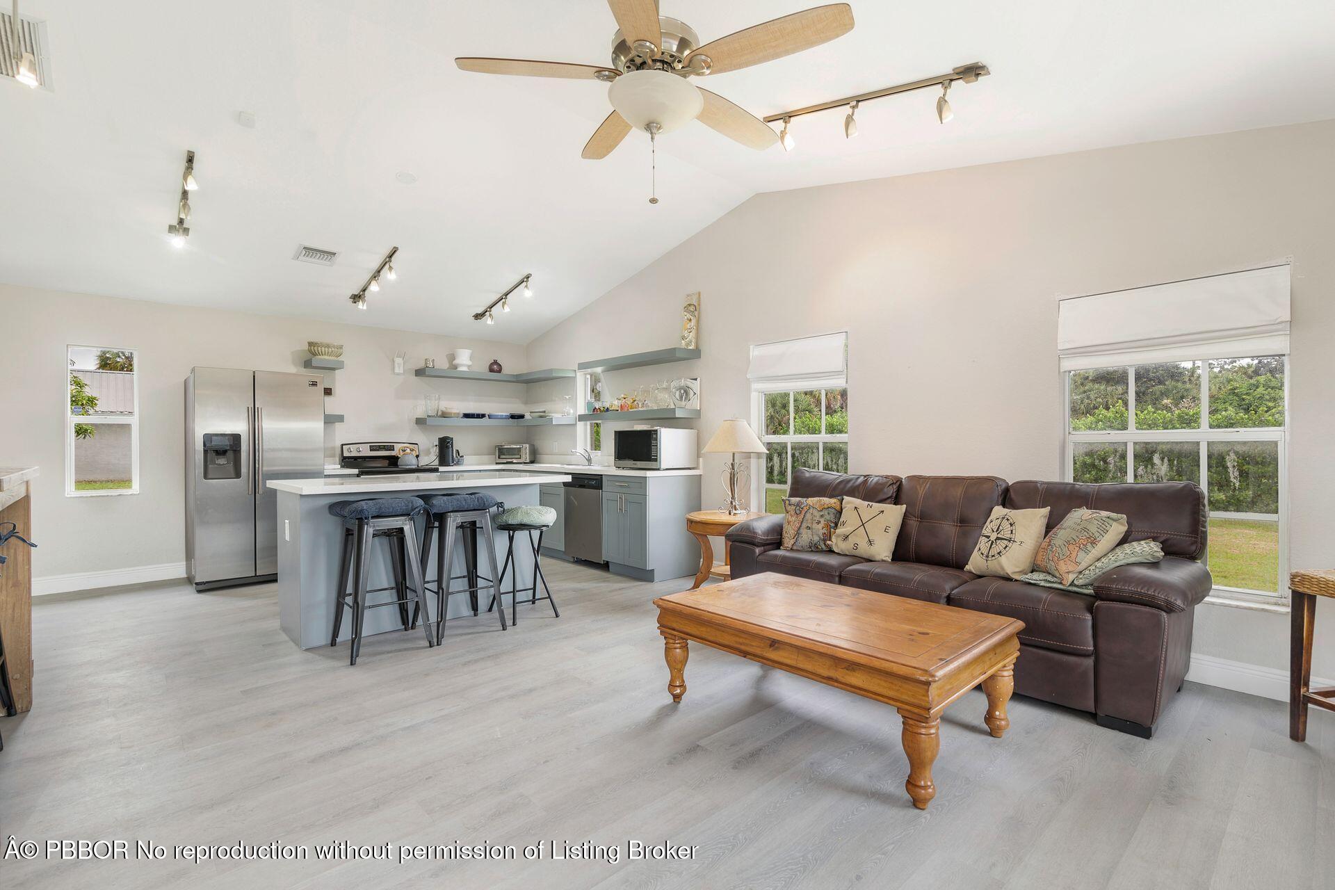 2770 E Road Loxahatchee, FL 33470 - Photo 21 of 51 a living room with lots of furniture and kitchen view