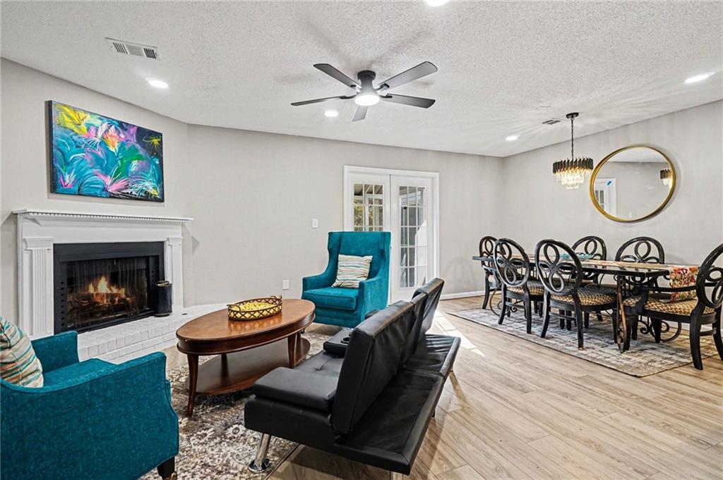 6052 WinterGreen Road Northwest Norcross, GA 30093 - Photo 1 of 24 a living room with furniture a table and a fireplace