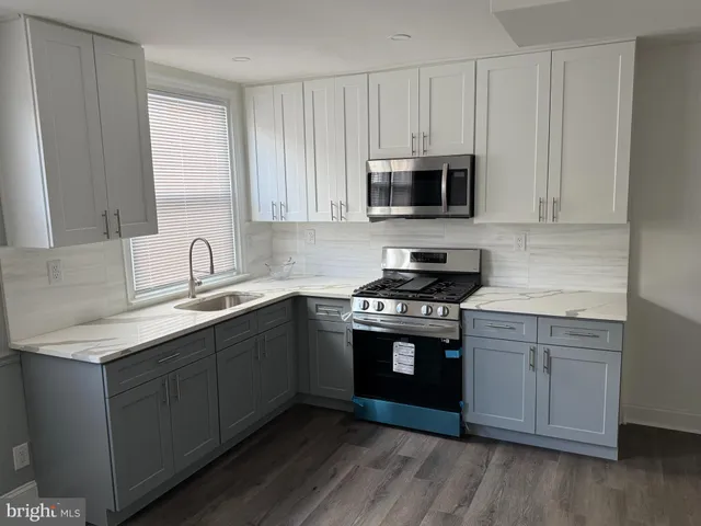 a kitchen with a refrigerator and a sink