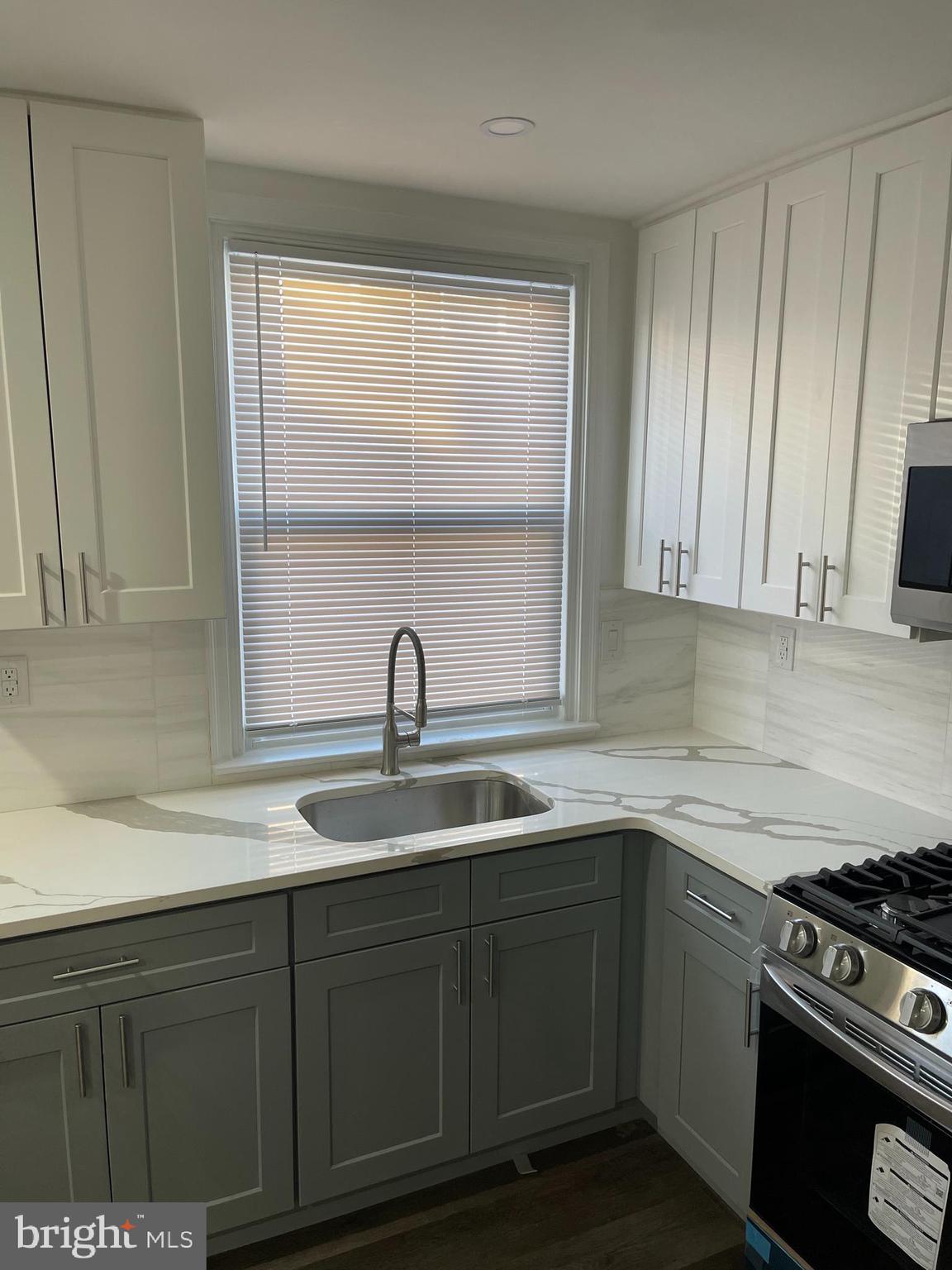 1353 Fanshawe Street Philadelphia, PA 19111 - Photo 9 of 41 a kitchen with a sink and cabinets