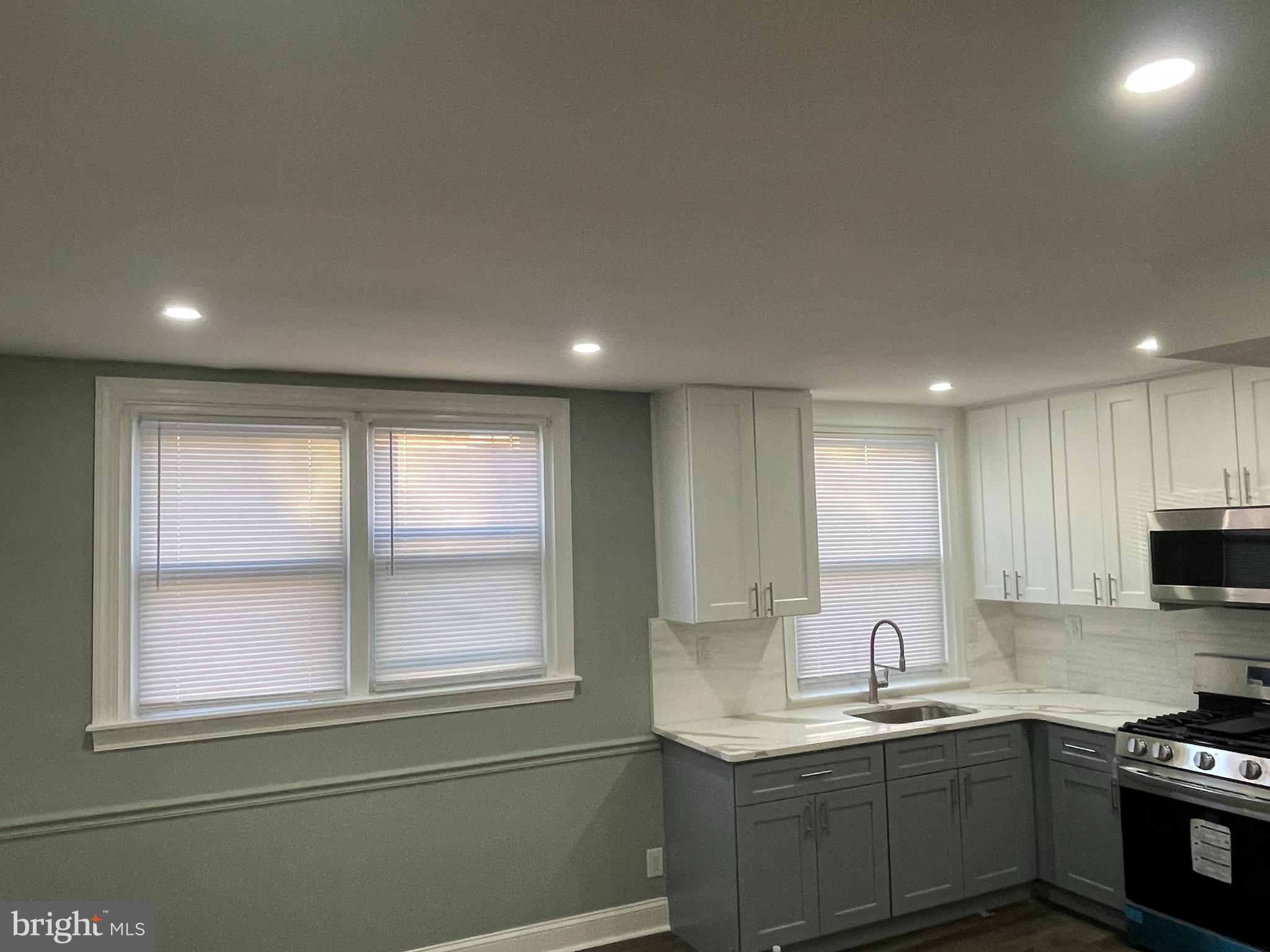 1353 Fanshawe Street Philadelphia, PA 19111 - Photo 10 of 41 a kitchen with a sink window and cabinets