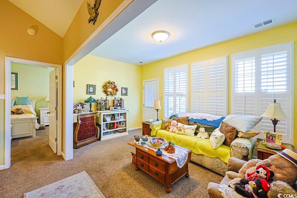 75 Field Planters Circle, Unit 75 Calabash, NC 28467 - Photo 12 of 40 Living room featuring carpet floors and lofted ceiling