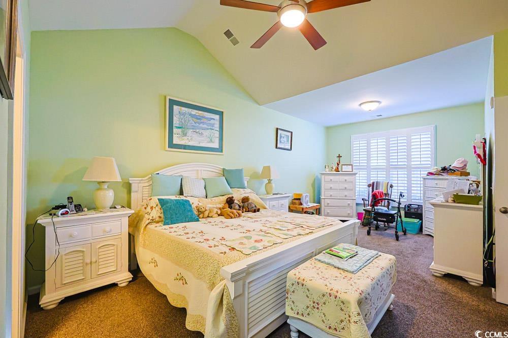 75 Field Planters Circle, Unit 75 Calabash, NC 28467 - Photo 14 of 40 Bedroom featuring dark carpet, ceiling fan, and lofted ceiling