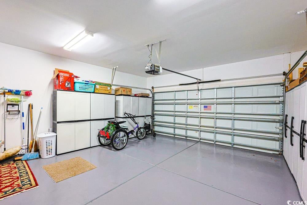 75 Field Planters Circle, Unit 75 Calabash, NC 28467 - Photo 36 of 40 Garage featuring a garage door opener