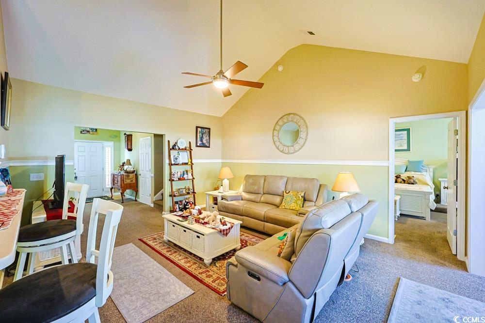75 Field Planters Circle, Unit 75 Calabash, NC 28467 - Photo 5 of 40 Carpeted living room featuring high vaulted ceiling and a ceiling fan