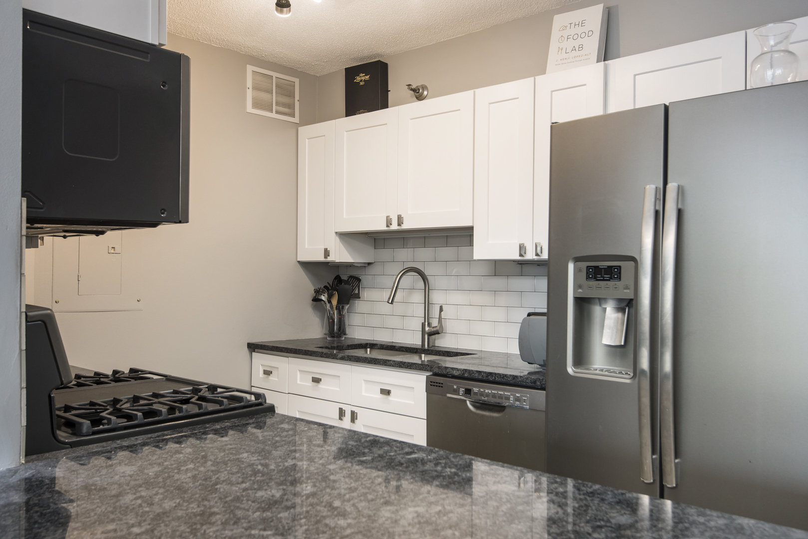 Undisclosed Address Chicago, IL 60610 - Photo 12 of 24 a kitchen with stainless steel appliances a refrigerator stove and microwave