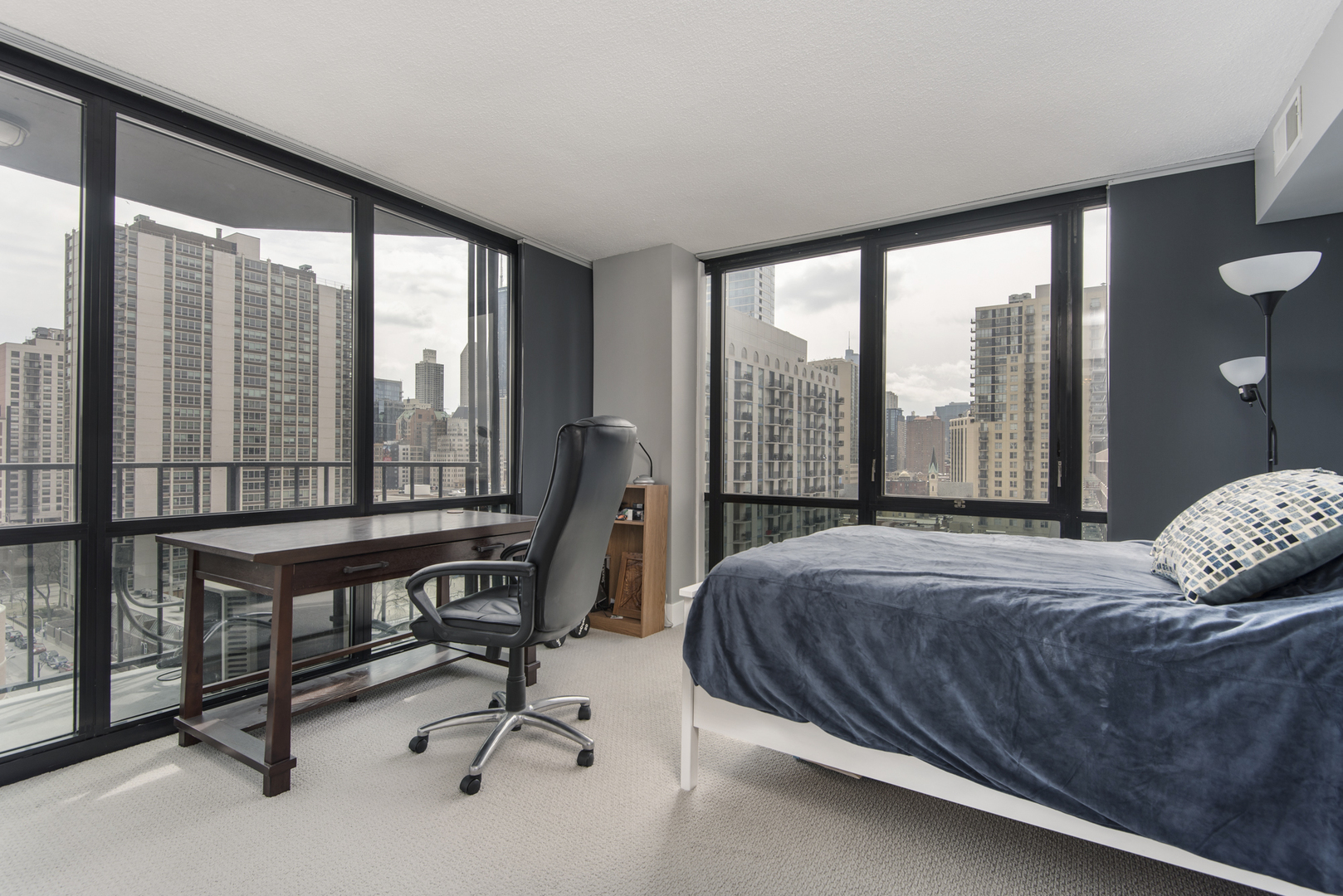 Undisclosed Address Chicago, IL 60610 - Photo 15 of 24 a bedroom with a bed and a large window