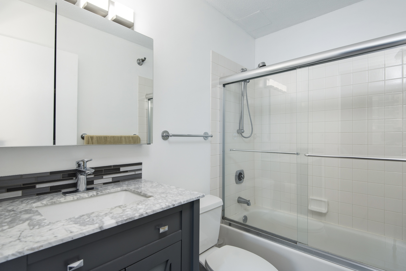 Undisclosed Address Chicago, IL 60610 - Photo 20 of 24 a bathroom with a granite countertop sink toilet and shower