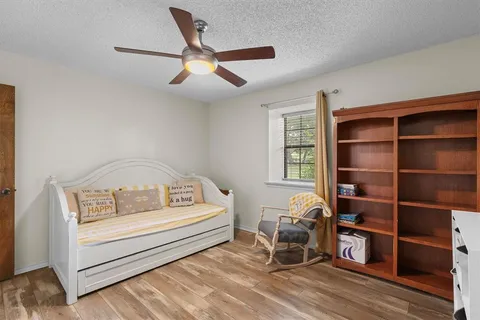 a bedroom with furniture and a window