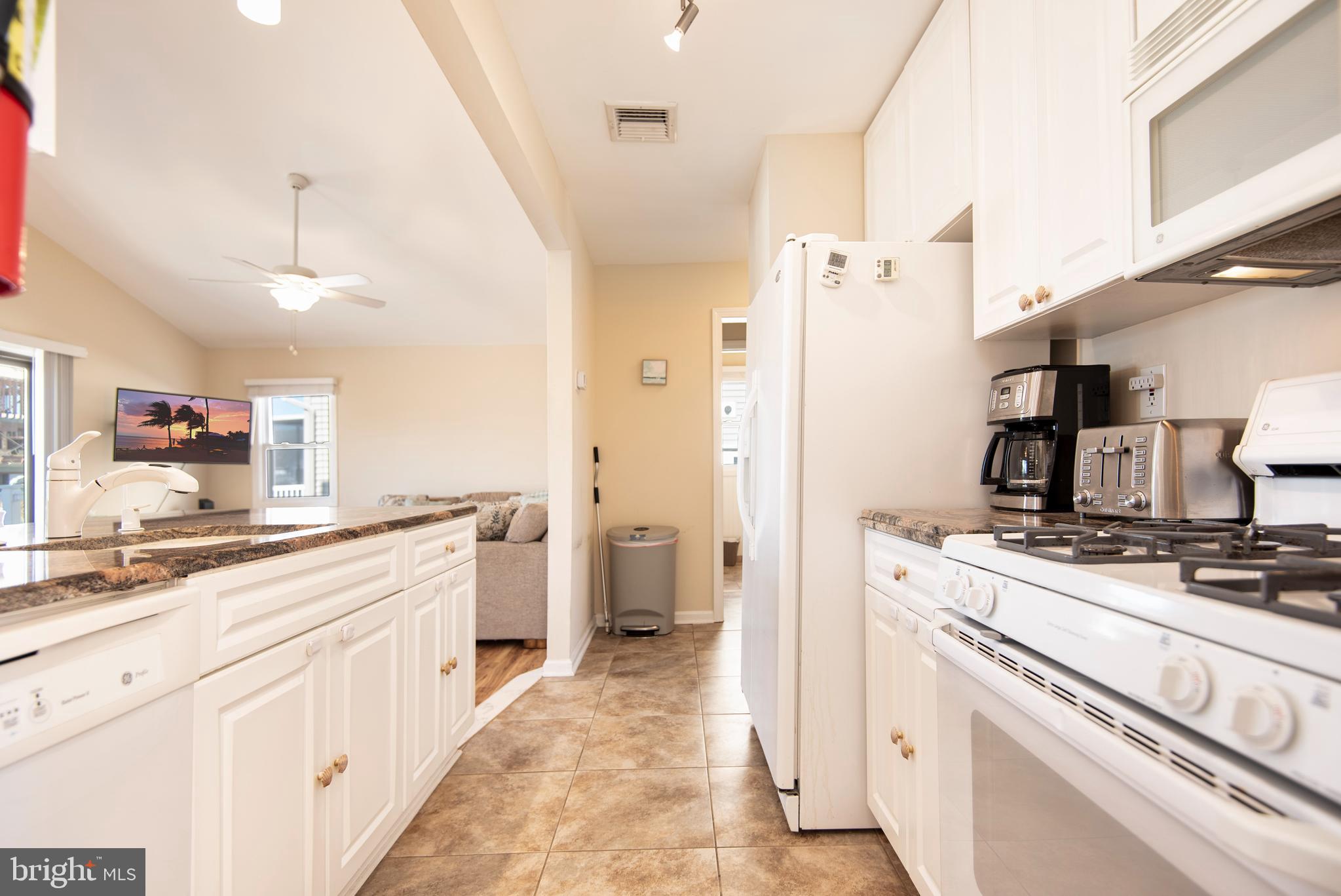 28 Diane Road Manahawkin, NJ 08050 - Photo 24 of 46 a kitchen with a stove and a refrigerator