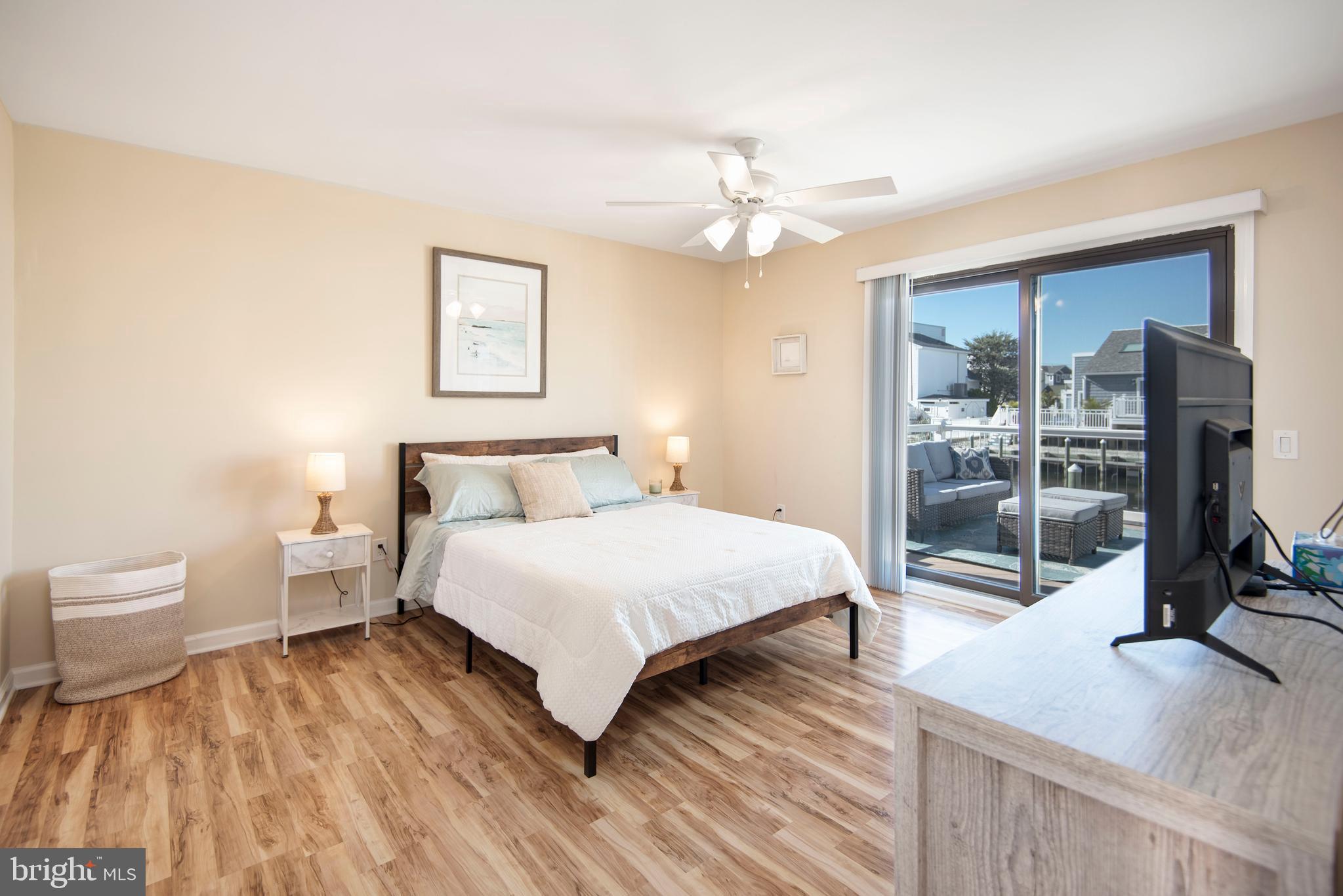 28 Diane Road Manahawkin, NJ 08050 - Photo 26 of 46 a spacious bedroom with a bed and a flat tv screen on the dresser