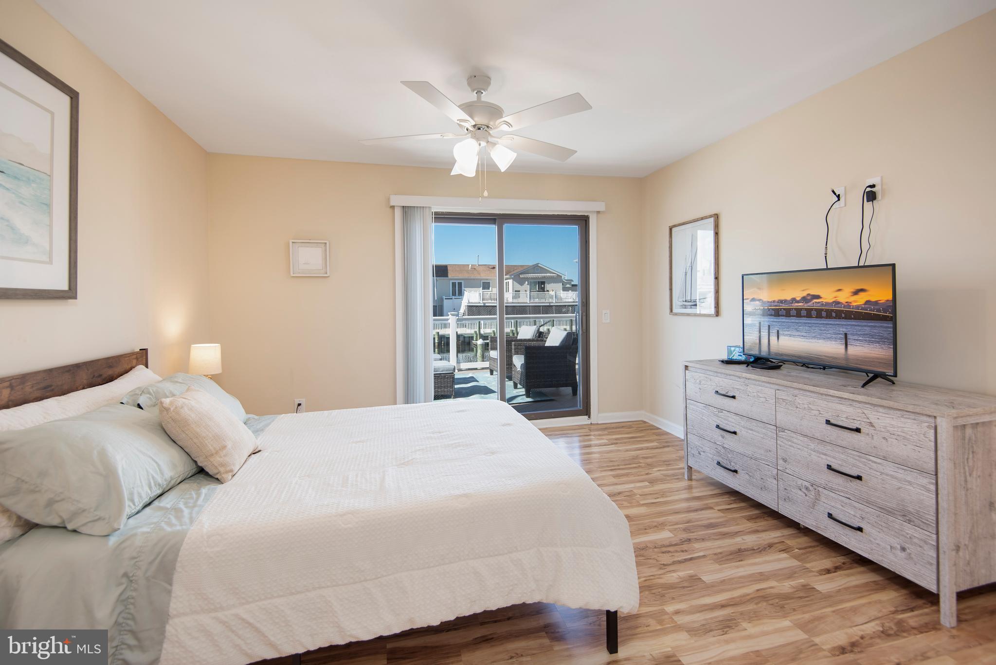 28 Diane Road Manahawkin, NJ 08050 - Photo 27 of 46 a bedroom with a large bed and a flat tv screen on dresser