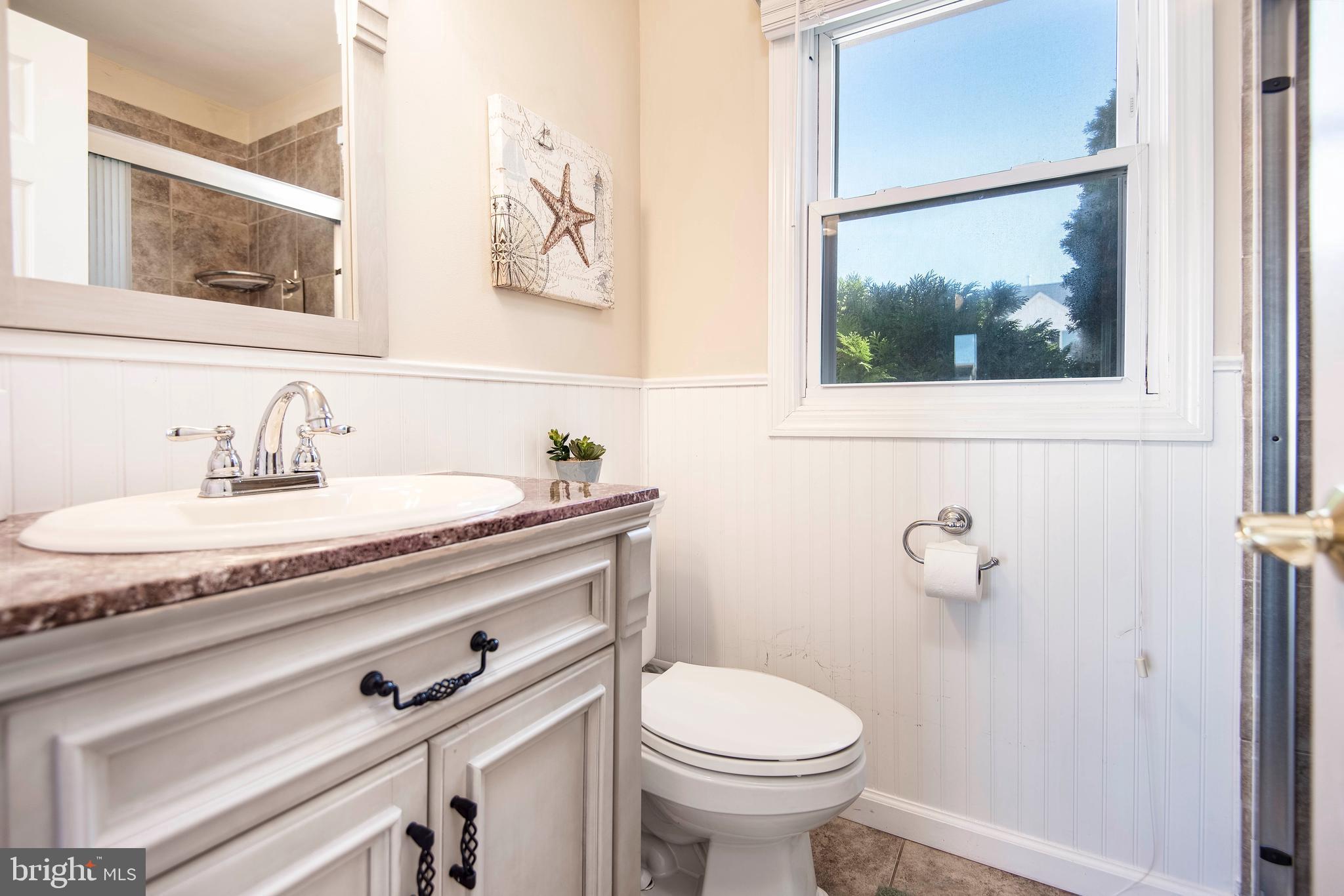 28 Diane Road Manahawkin, NJ 08050 - Photo 30 of 46 a bathroom with a granite countertop sink and a toilet