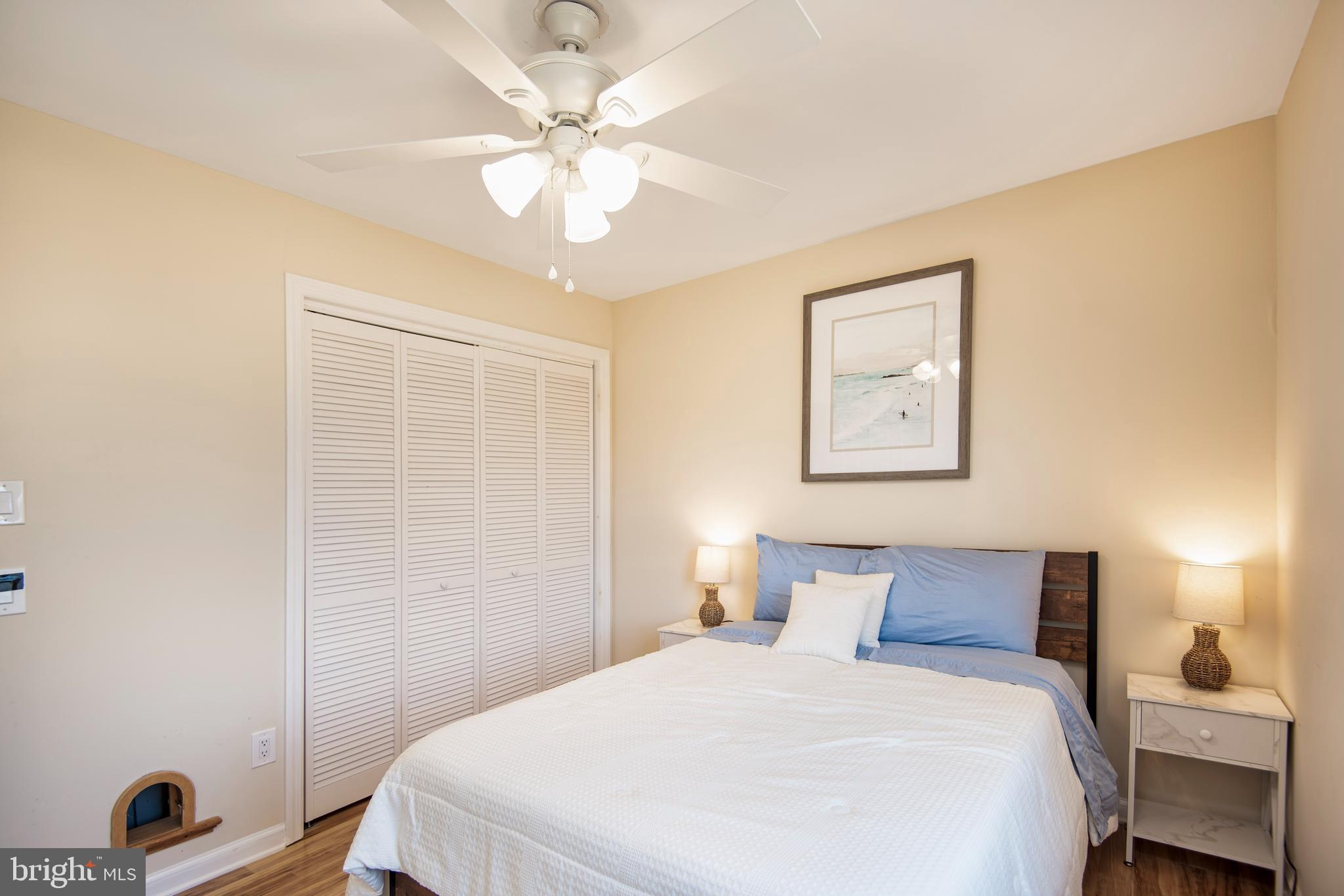 28 Diane Road Manahawkin, NJ 08050 - Photo 36 of 46 a bedroom with a bed and a chandelier