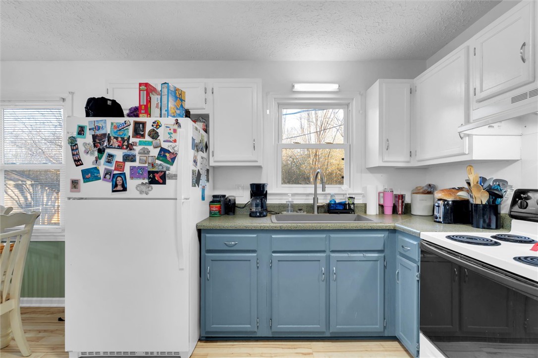 11 Trammell Street Liberty, SC 29657 - Photo 11 of 24 This kitchen features classic cabinetry, ample counter space, and durable flooring.