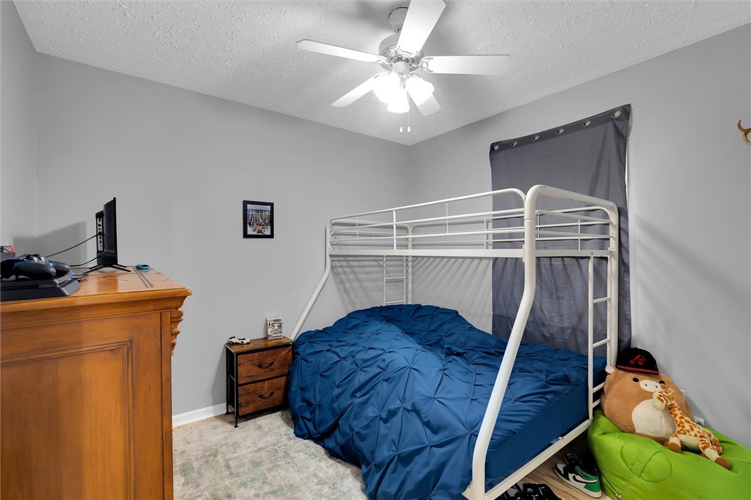 11 Trammell Street Liberty, SC 29657 - Photo 21 of 24 This spacious bedroom offers a comfortable and functional living space, perfect for any resident.