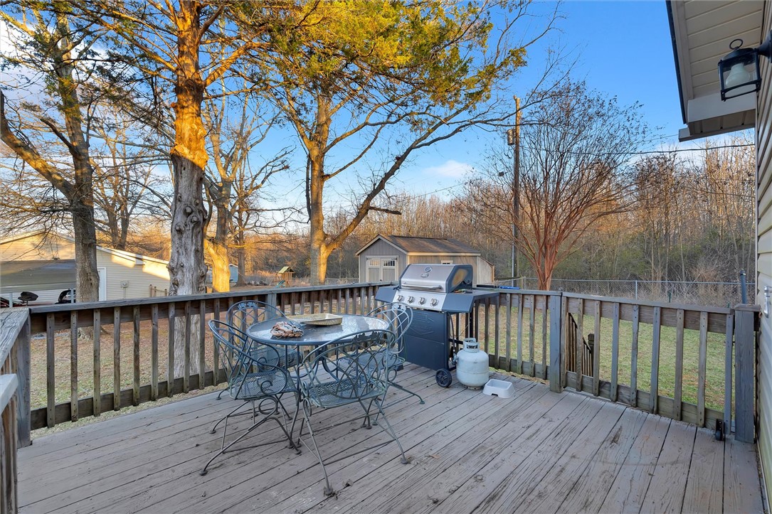 11 Trammell Street Liberty, SC 29657 - Photo 22 of 24 This spacious wooden deck offers serene views and an ideal setting for outdoor gatherings.