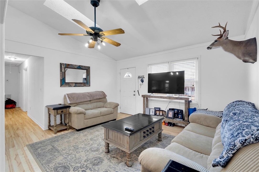 11 Trammell Street Liberty, SC 29657 - Photo 6 of 24 This inviting living room features vaulted ceilings, warm hardwood floors, and abundant natural light.