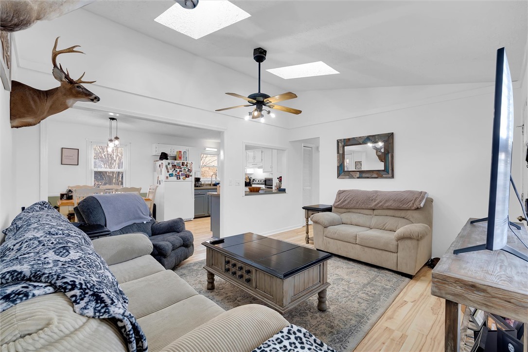 11 Trammell Street Liberty, SC 29657 - Photo 7 of 24 Bright and airy living space seamlessly connects to a functional kitchen, creating an inviting atmosphere.