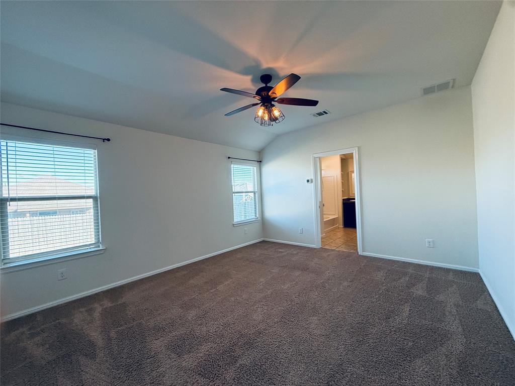9328 Castorian Drive Fort Worth, TX 76131 - Photo 11 of 24 an empty room with windows and ceiling fan