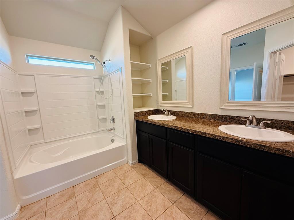 9328 Castorian Drive Fort Worth, TX 76131 - Photo 14 of 24 a bathroom with a granite countertop sink mirror and a bath tub