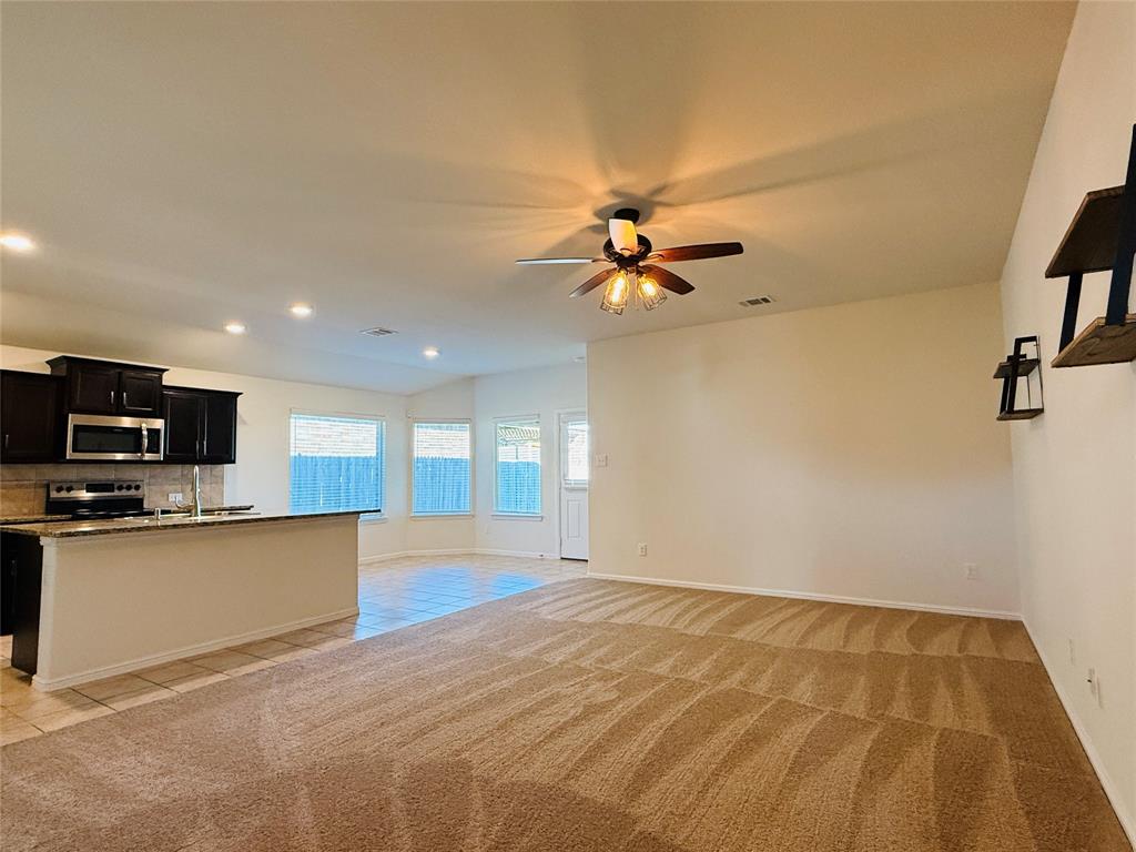 9328 Castorian Drive Fort Worth, TX 76131 - Photo 5 of 24 a view of a kitchen with a sink microwave and cabinets