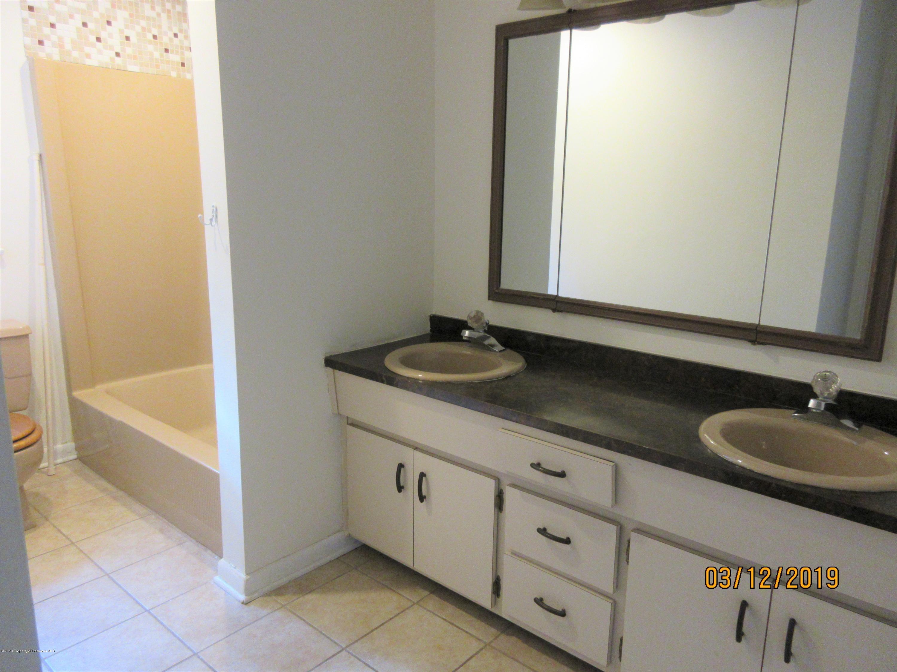 719 North Abington Road Clarks Summit, PA 18411 - Photo 19 of 37 a bathroom with a granite countertop sink and a mirror