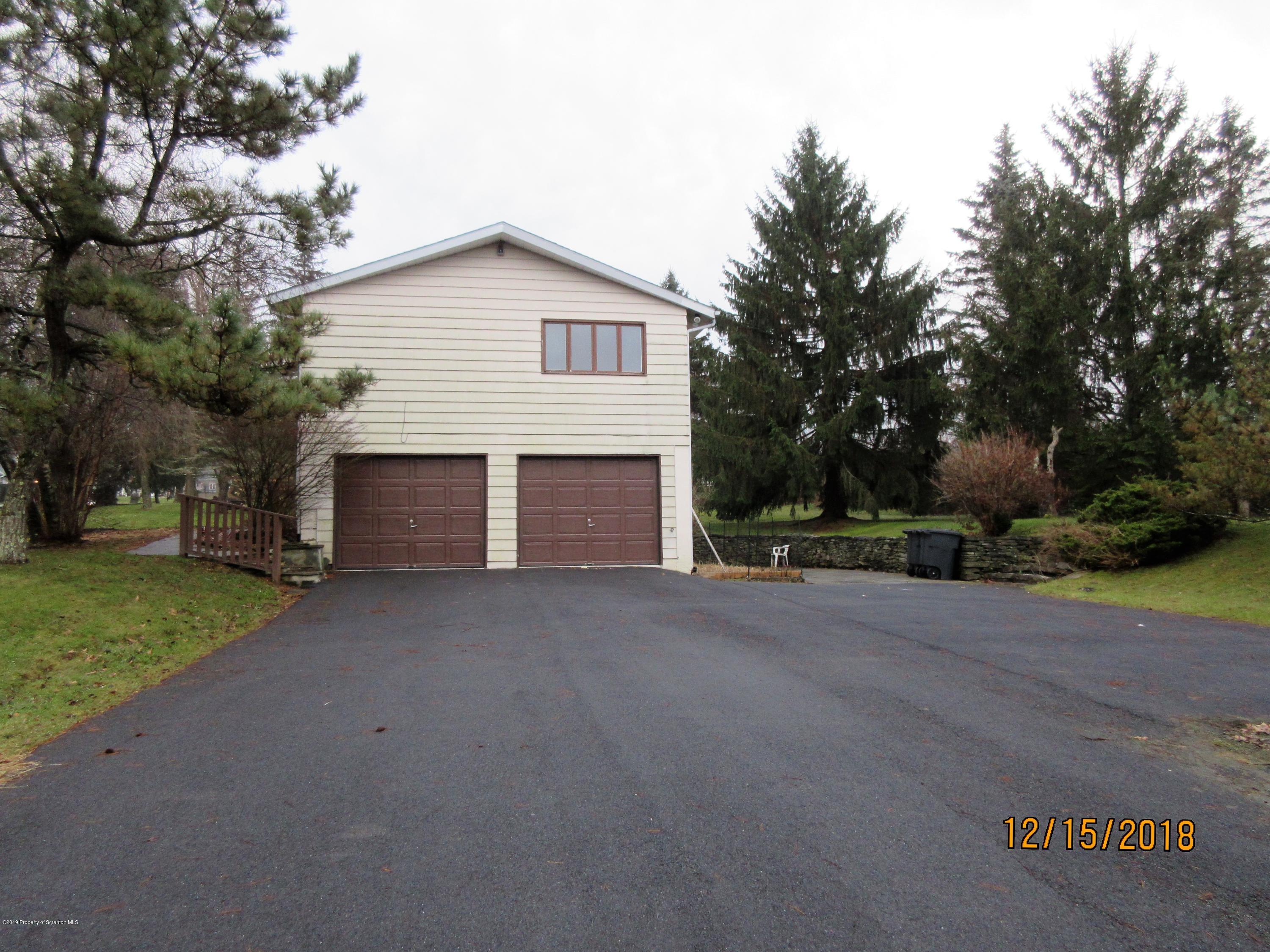 719 North Abington Road Clarks Summit, PA 18411 - Photo 34 of 37 a view of a house with a yard and garage