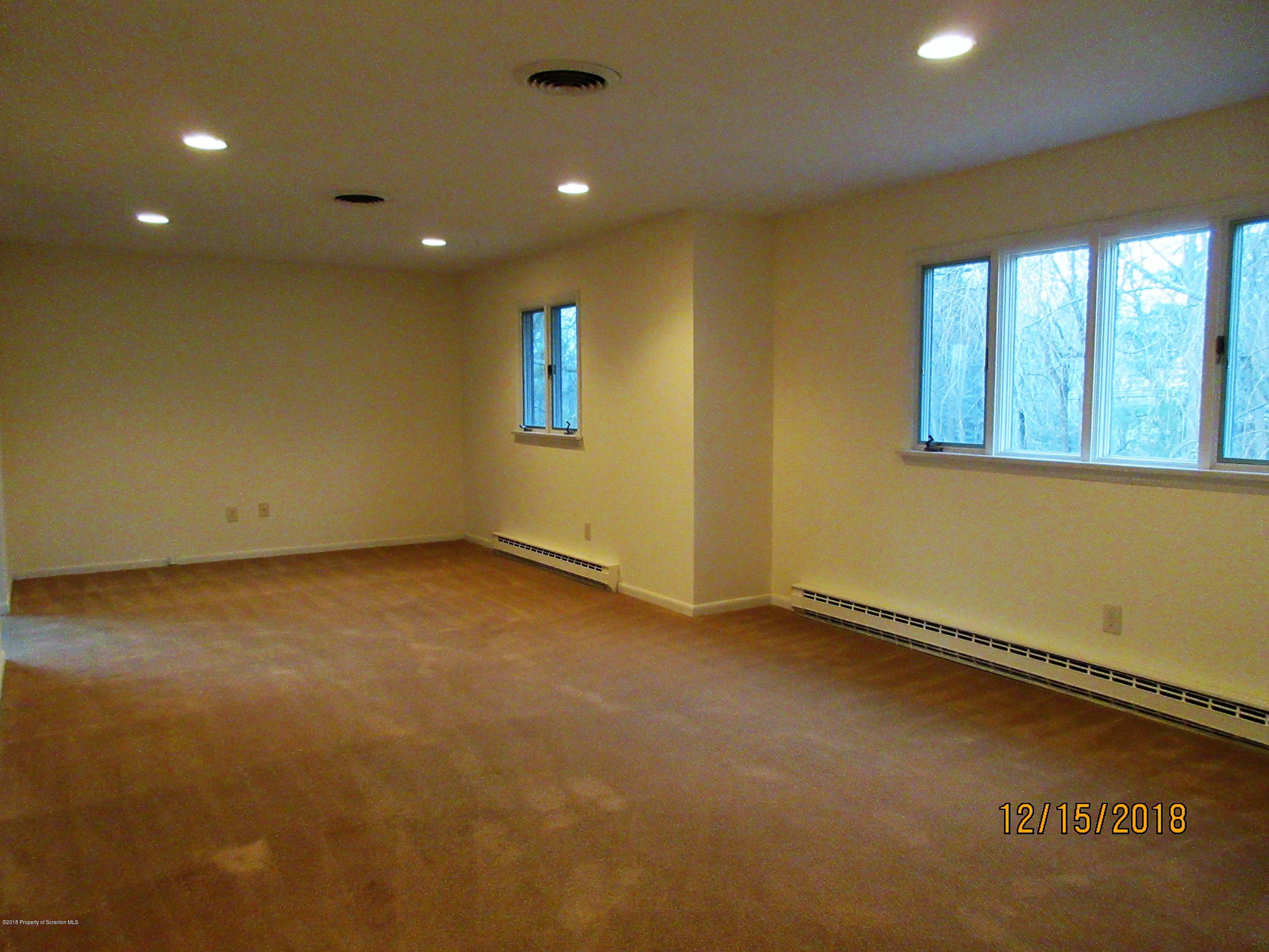 719 North Abington Road Clarks Summit, PA 18411 - Photo 4 of 37 an empty room with a empty space and windows