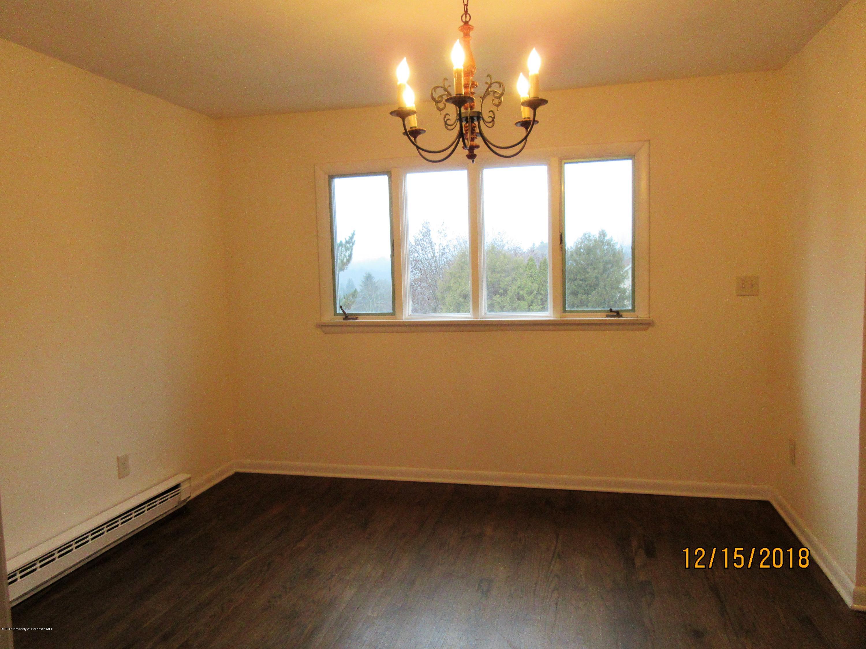 719 North Abington Road Clarks Summit, PA 18411 - Photo 6 of 37 a view of an empty room with wooden floor and a window