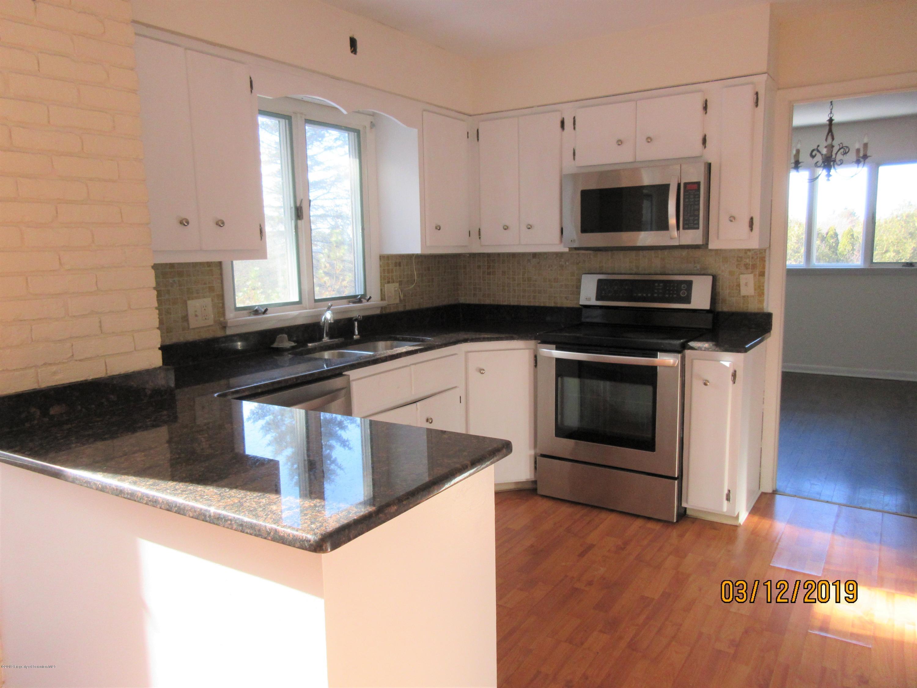 719 North Abington Road Clarks Summit, PA 18411 - Photo 8 of 37 a kitchen with granite countertop a stove top oven and cabinets