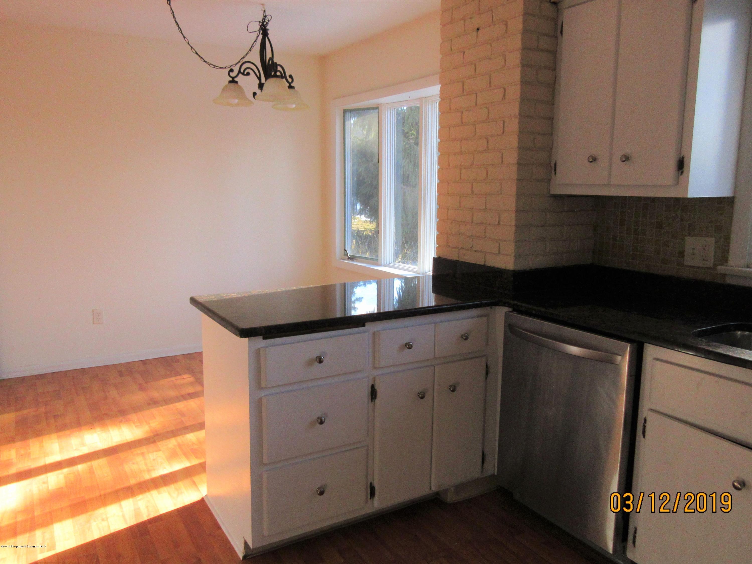719 North Abington Road Clarks Summit, PA 18411 - Photo 9 of 37 a kitchen with granite countertop white cabinets and a black appliances