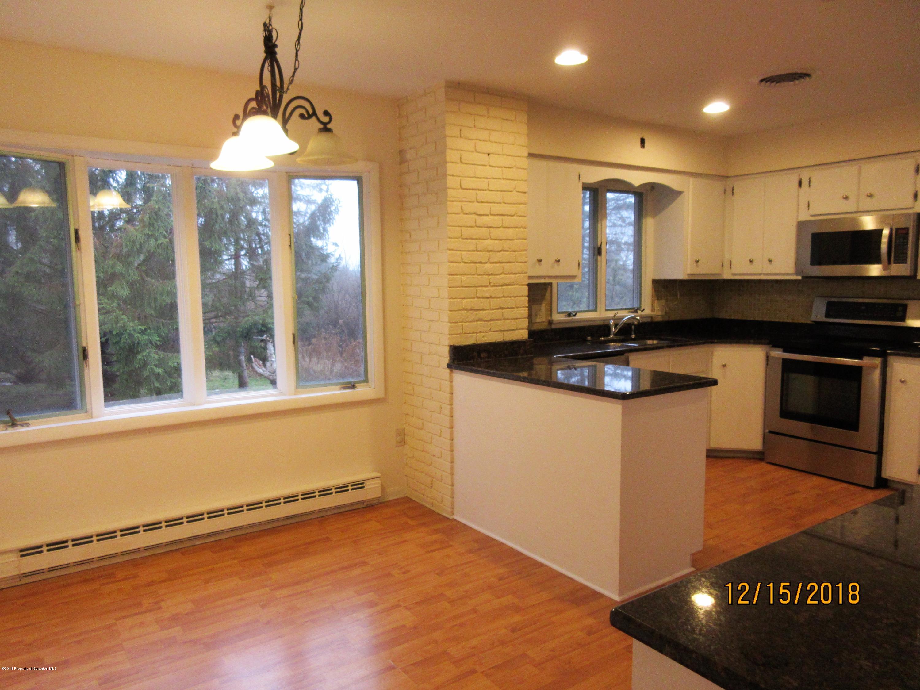 719 North Abington Road Clarks Summit, PA 18411 - Photo 10 of 37 a kitchen with stainless steel appliances granite countertop a stove a sink and a microwave