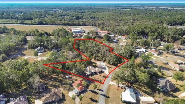 an aerial view of house with yard