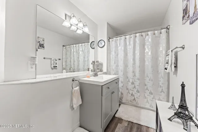 a bathroom with a double vanity sink mirror and shower