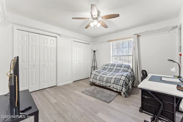 a bedroom with a bed window and a table