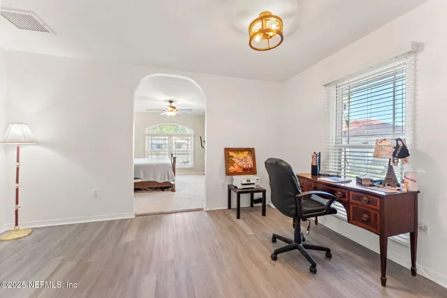 a view of a workspace with furniture and a window