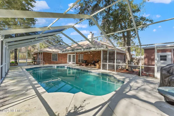 a view of a swimming pool with a patio