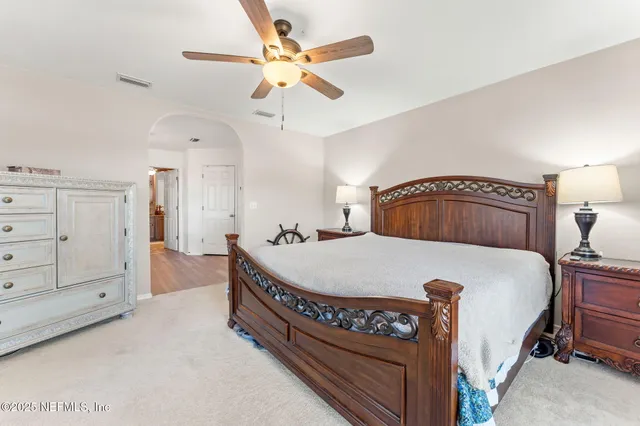 a bedroom with a bed and a dresser