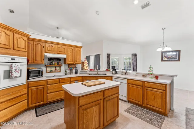 a large white kitchen with a large window