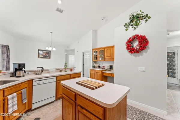 a large white kitchen with a large window