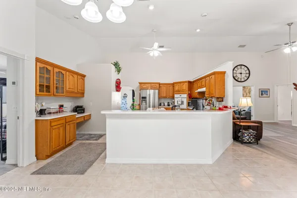 a living room with furniture a clock and a window