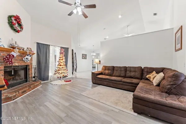 a view of a dining room with furniture and wooden floor