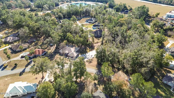 a aerial view of a houses with yard