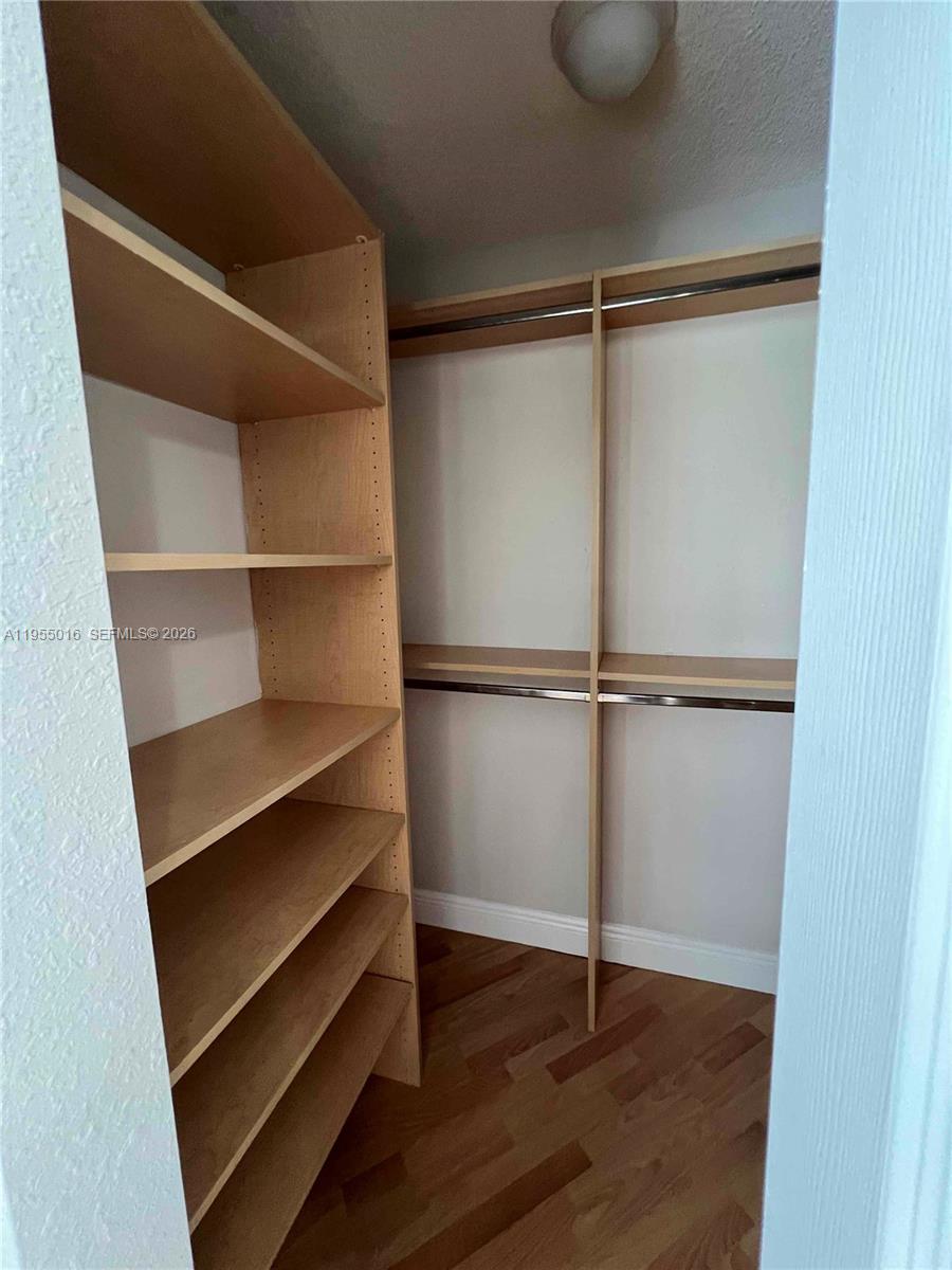 10785 Southwest 108th Avenue, Unit 308 Miami, FL 33176 - Photo 14 of 21 a room with walk in closet and wooden floor