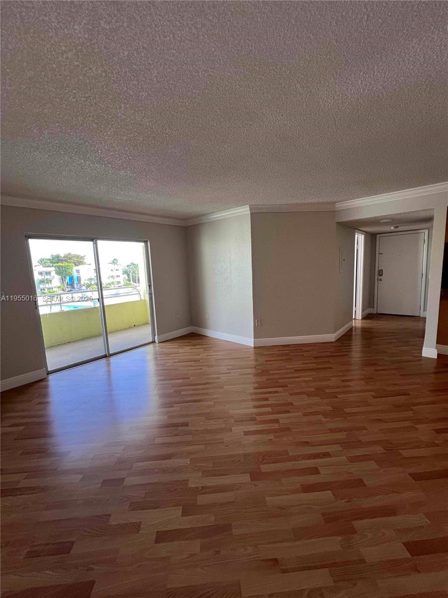 10785 Southwest 108th Avenue, Unit 308 Miami, FL 33176 - Photo 3 of 21 a view of an empty room with wooden floor and a window