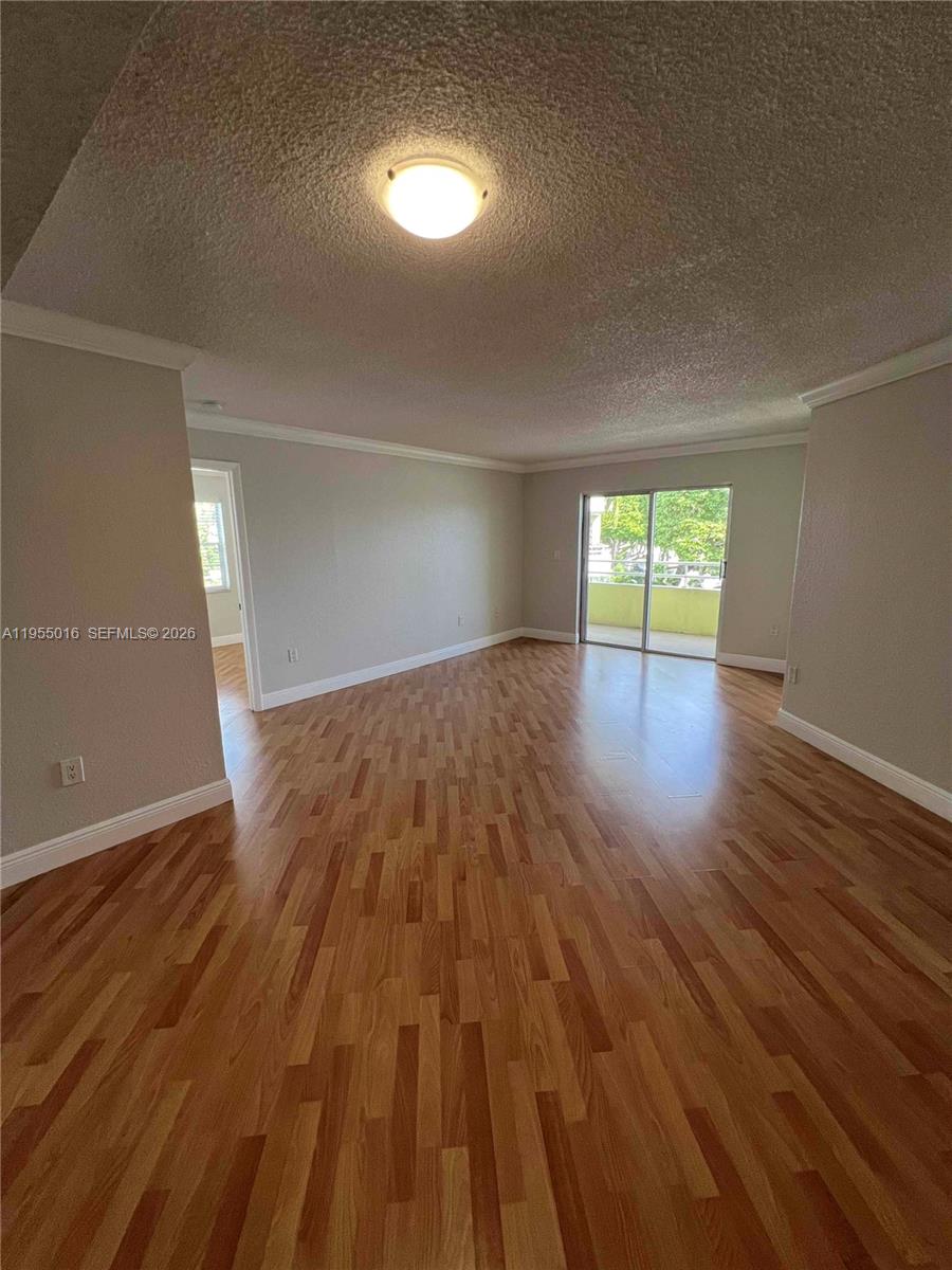 10785 Southwest 108th Avenue, Unit 308 Miami, FL 33176 - Photo 4 of 21 wooden floor in an empty room with a window